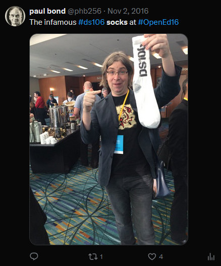 a man holding a pair of ds106 socks