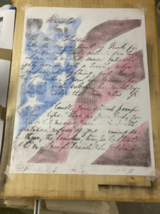 artwork in progress showing handwritten text image combined with flag
