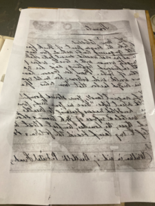 reversed image of a handwritten draft of The New Colossus